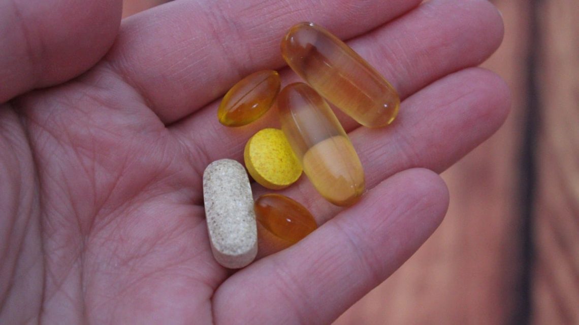 person holding medication pills