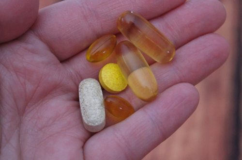 person holding medication pills