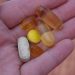person holding medication pills
